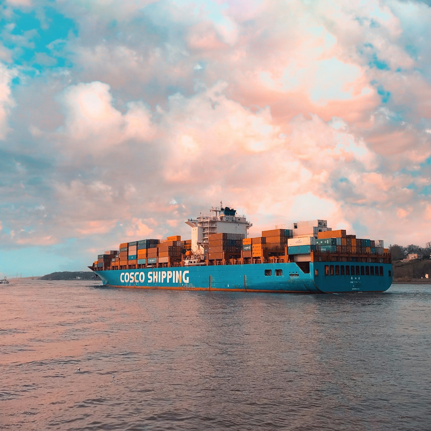 Container ship moving through port waters